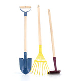 Colorful kids' gardening tool set featuring a blue shovel, yellow rake, and purple hoe with long wooden handles.