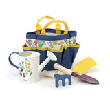 Colorful Vilac kids' garden tool set with watering can, trowel, rake, and patterned tote bag on a white background.