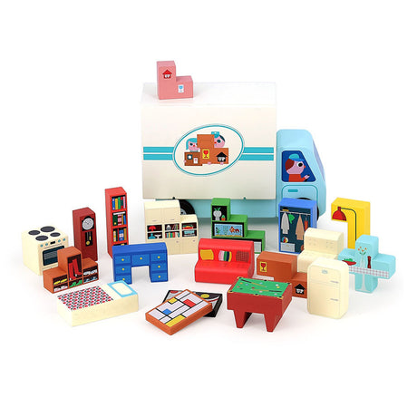 Wooden toy moving truck surrounded by colorful miniature block furniture items like a bed, sofa, and stove.