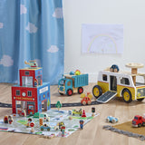 Wooden rescue station play set with toy fire truck, ambulance, police station, and mat.