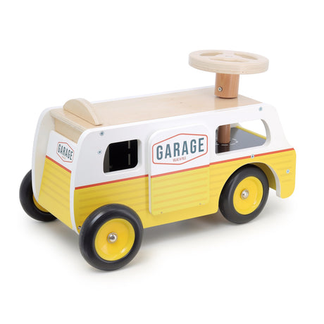 Vilac wooden ride-on van toy in yellow and white with steering wheel and "Garage" logo.
