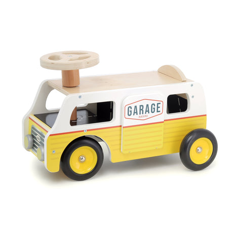 Vilac yellow and white wooden ride-on garage van toy with steering wheel for toddlers on white background.