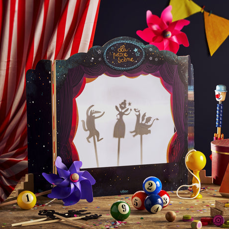 Tabletop shadow puppet theatre showing fairytale silhouettes on screen surrounded by colorful toys.