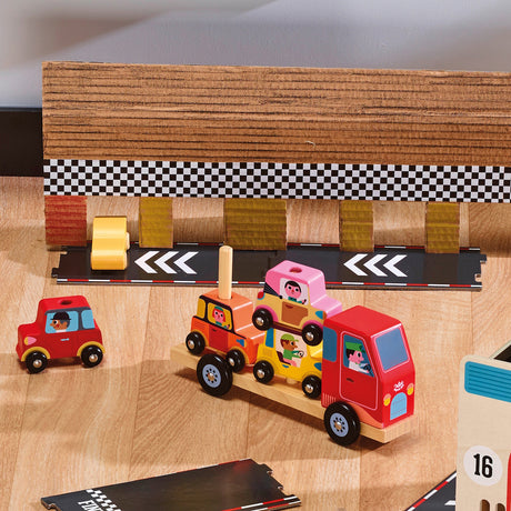 Wooden toy car carrier truck transporting colorful cars on a play track with a checkered racing finish line.