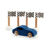 Blue wooden toy car racing past four checkered finish line flags on a white background.