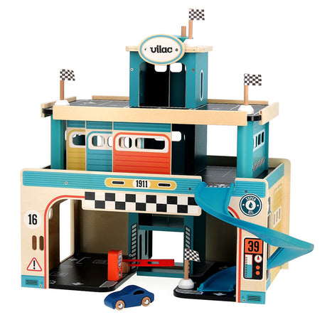 Vilac large multi-story wooden toy car garage with blue ramp, racing flags, gas pump, and small blue car on white background.
