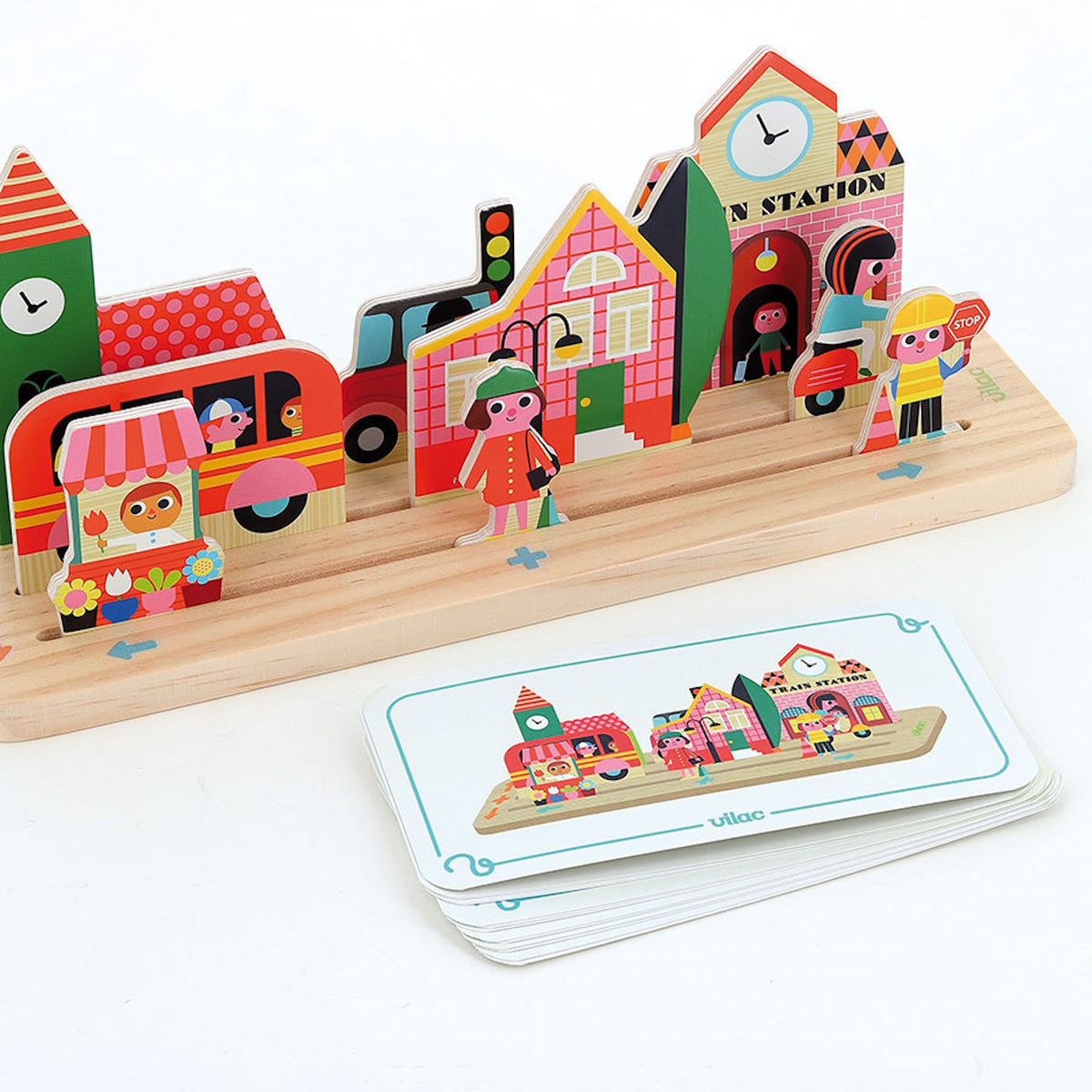 Vilac wooden toy city puzzle with buildings, vehicles, and a guide card for kids spatial development.