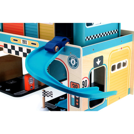 Close-up of Vilac wooden toy garage with a blue car on a curved ramp, featuring vintage racing details and flags.
