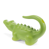 Green crocodile-shaped plastic watering can for gardening, side view with curved tail handle on a white background.
