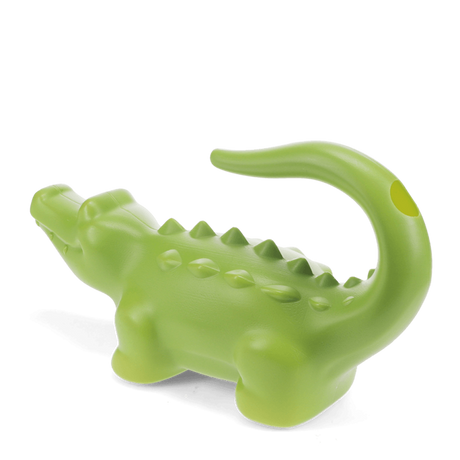 Green crocodile-shaped plastic watering can for gardening, side view with curved tail handle on a white background.