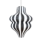 Hanging wavy-shaped paper lantern featuring vertical black and white stripes on a plain background.