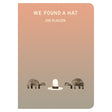 Book cover for We Found a Hat by Jon Klassen featuring two turtles looking at a tall white hat on a tan gradient background.