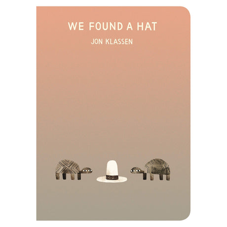 Book cover for We Found a Hat by Jon Klassen featuring two turtles looking at a tall white hat on a tan gradient background.