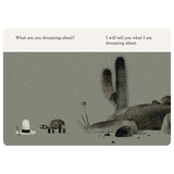 A turtle stands next to a white hat in a desert at night with cacti and stars. Text asks about dreaming.