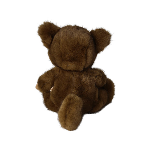 Back view of a seated plush doll in a fuzzy brown werewolf costume showing its tail and ears.