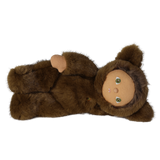 Plush doll in a brown werewolf costume lying on its side against a white background.