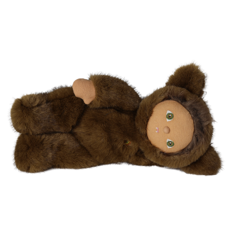 Plush doll in a brown werewolf costume lying on its side against a white background.