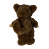 Back view of a plush doll in a fuzzy brown werewolf suit showing its tail and bear ears.
