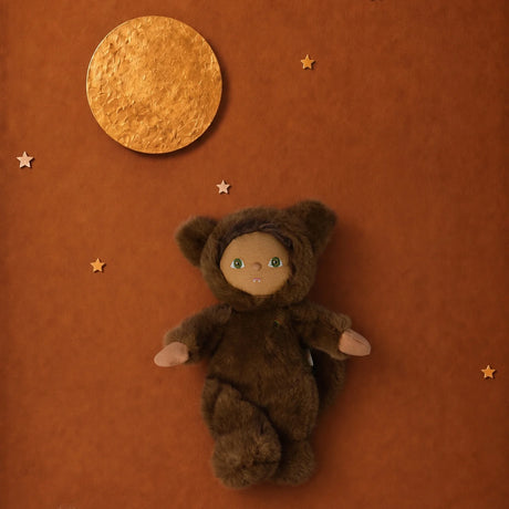 Plush doll in a brown werewolf suit against a brown backdrop with a gold full moon and small stars.
