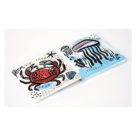 Illustrated children's bath book spread featuring a red crab and a purple jellyfish with playful "snip snap" and "jiggly" text.