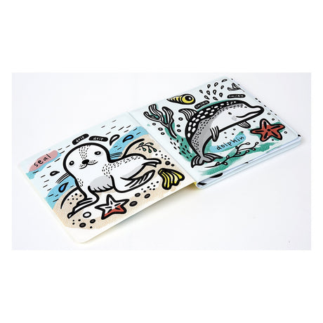 Illustrated children's bath book pages featuring a white seal and a spotted dolphin with colorful sea stars and seaweed.