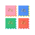 Four colorful Happy Birthday napkins in pink, blue, green, and red with scalloped edges and gold text.