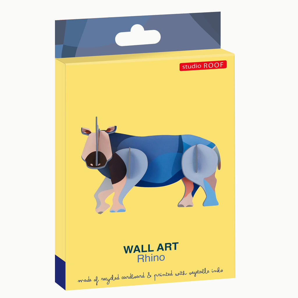 Yellow packaging of "Studio Roof" wall art featuring a stylized, colorful rhino. Text highlights recycled cardboard and vegetable inks.