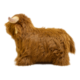 Fluffy brown plush toy resembling a Highland cow, with long fur and curved horns, set against a white background, conveying a cozy and whimsical feel.
