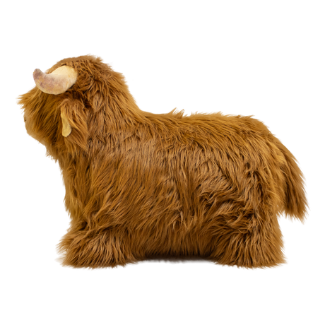 Fluffy brown plush toy resembling a Highland cow, with long fur and curved horns, set against a white background, conveying a cozy and whimsical feel.