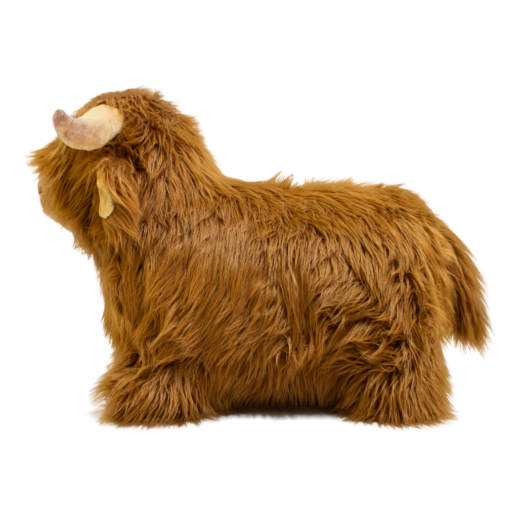 Fluffy brown plush toy resembling a Highland cow, with long fur and curved horns, set against a white background, conveying a cozy and whimsical feel.