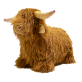 Fluffy brown plush toy resembling a Highland cow, with long fur and curved horns, set against a white background, conveying a cozy and whimsical feel.