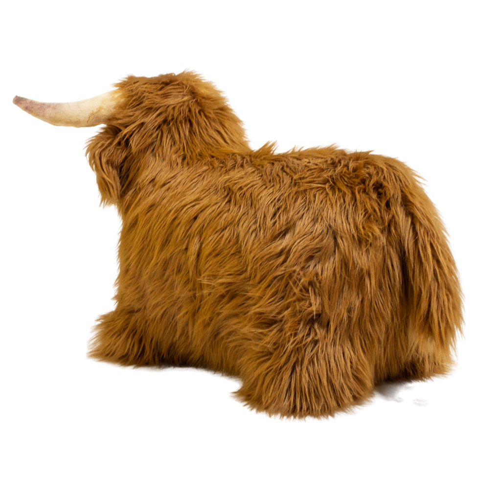 Fluffy brown plush toy resembling a Highland cow, with long fur and curved horns, set against a white background, conveying a cozy and whimsical feel.