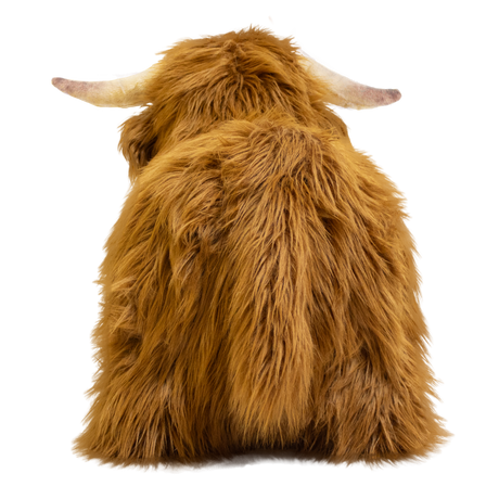 Fluffy brown plush toy resembling a Highland cow, with long fur and curved horns, set against a white background, conveying a cozy and whimsical feel.