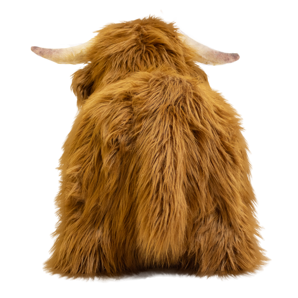 Fluffy brown plush toy resembling a Highland cow, with long fur and curved horns, set against a white background, conveying a cozy and whimsical feel.
