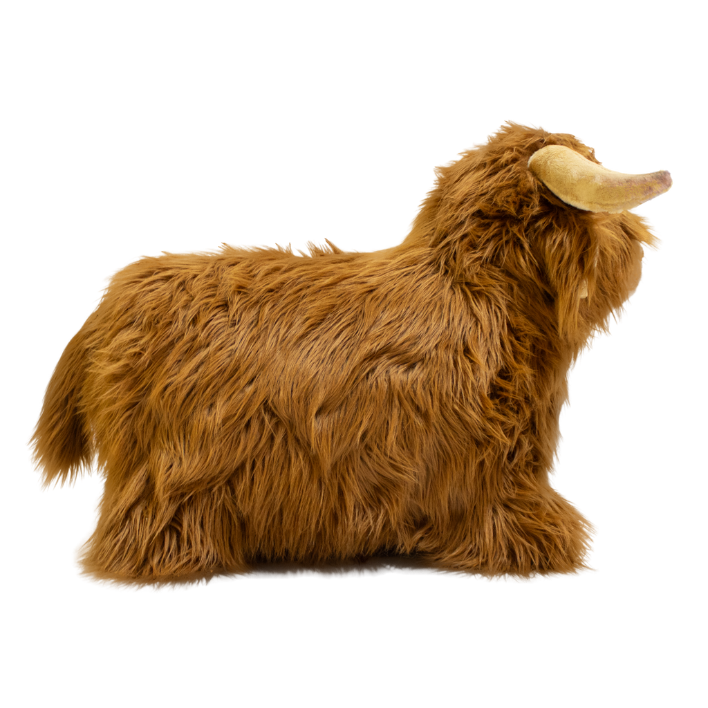 Fluffy brown plush toy resembling a Highland cow, with long fur and curved horns, set against a white background, conveying a cozy and whimsical feel.
