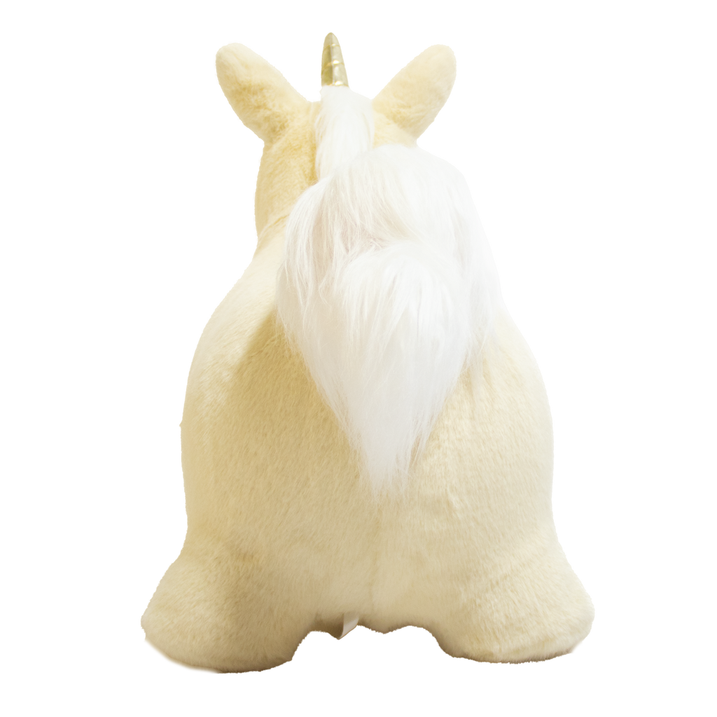 A plush unicorn toy with a golden horn and fluffy white mane and tail stands against a white background. The unicorn has a soft, cuddly appearance.