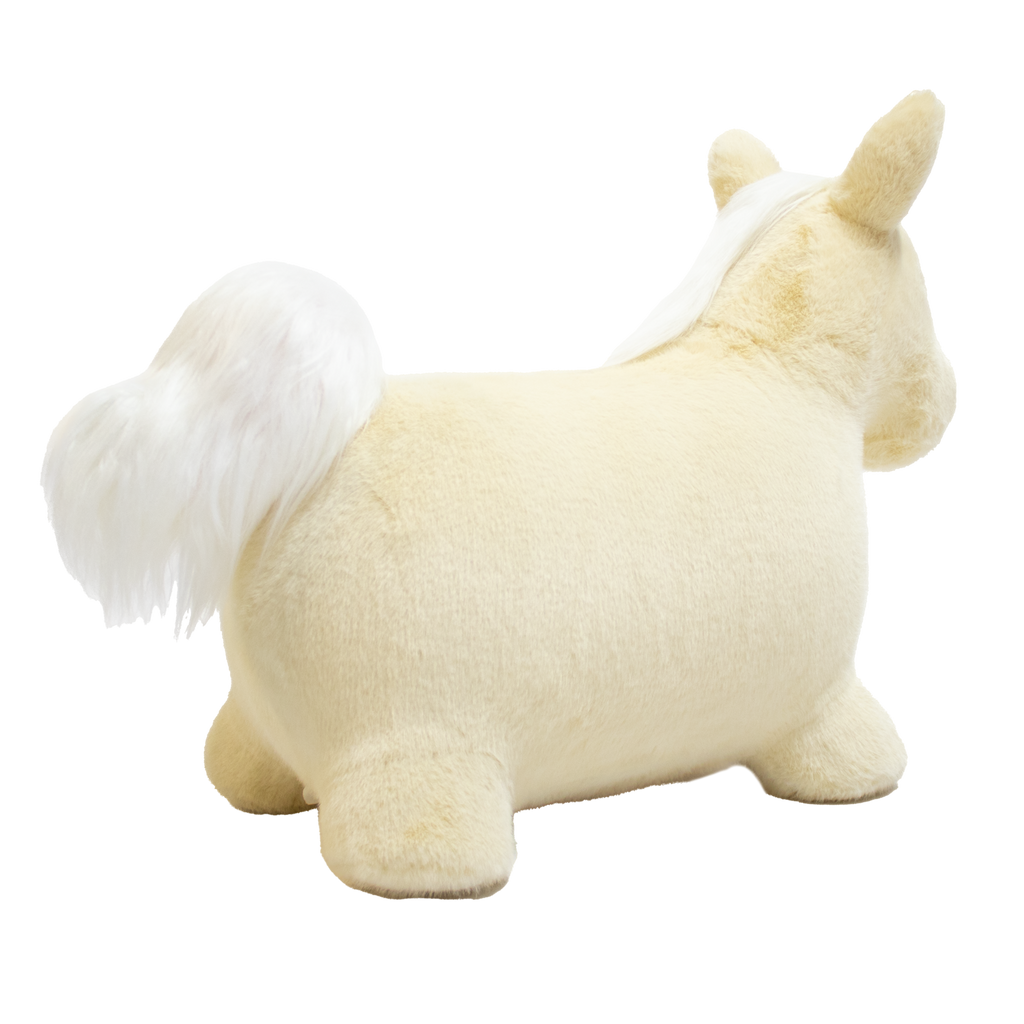 A plush unicorn toy with a golden horn and fluffy white mane and tail stands against a white background. The unicorn has a soft, cuddly appearance.