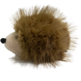 A plush hedgehog toy with a round, white face and soft, brown, spiky fur against a solid white background. The toy is cute and inviting.