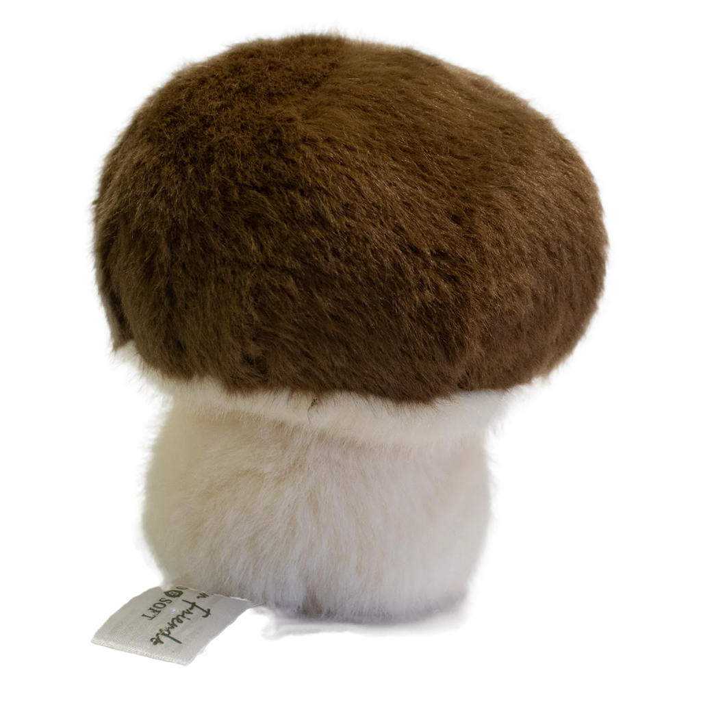 A plush toy shaped like a mushroom with a fluffy white stem and a round, brown cap. It has a smiling face, exuding a cute and cheerful vibe.