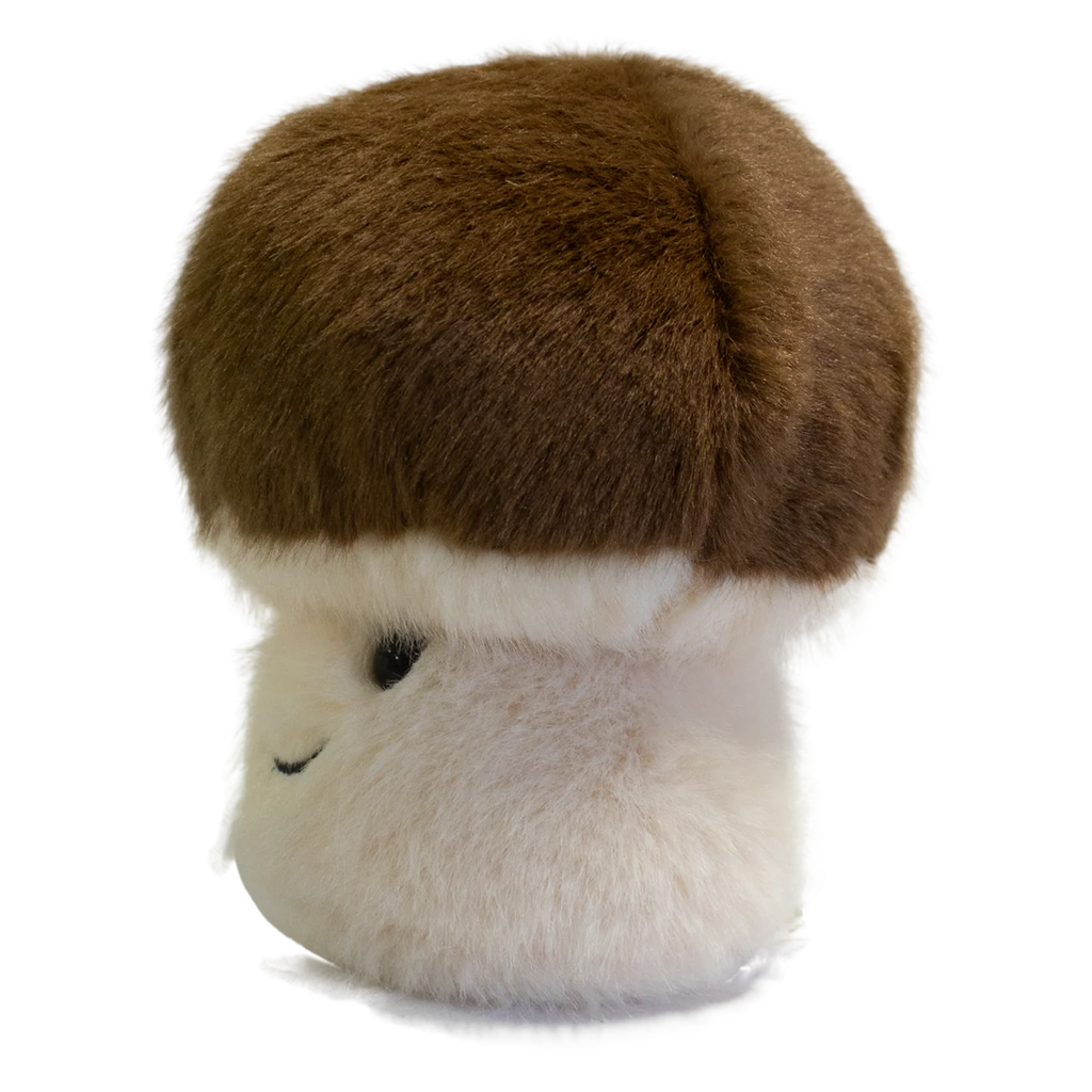 A plush toy shaped like a mushroom with a fluffy white stem and a round, brown cap. It has a smiling face, exuding a cute and cheerful vibe.