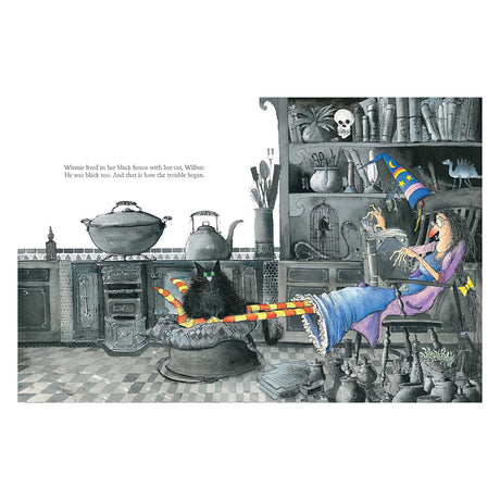 Winnie the Witch sitting in her black kitchen with Wilbur the cat, from the Winnie and Wilbur children's book series.