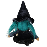 Back view of a seated plush witch doll with teal pigtails and a tall pointed black hat.