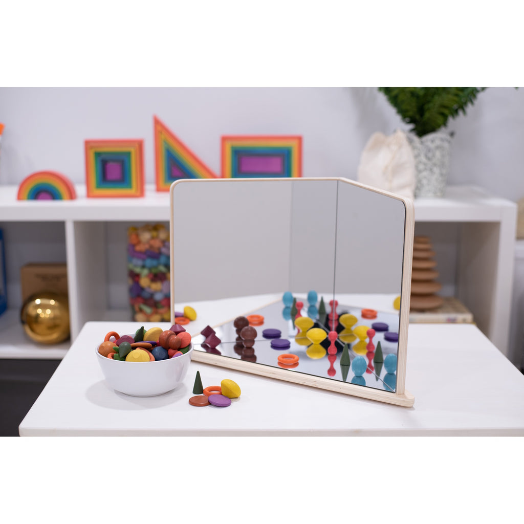 A wooden-framed mirror with four reflective panels arranged to create kaleidoscopic visual effects, ideal for sensory exploration and light play.