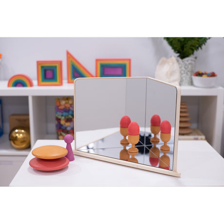 A wooden-framed mirror with four reflective panels arranged to create kaleidoscopic visual effects, ideal for sensory exploration and light play.