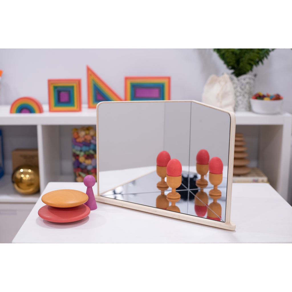 A wooden-framed mirror with four reflective panels arranged to create kaleidoscopic visual effects, ideal for sensory exploration and light play.