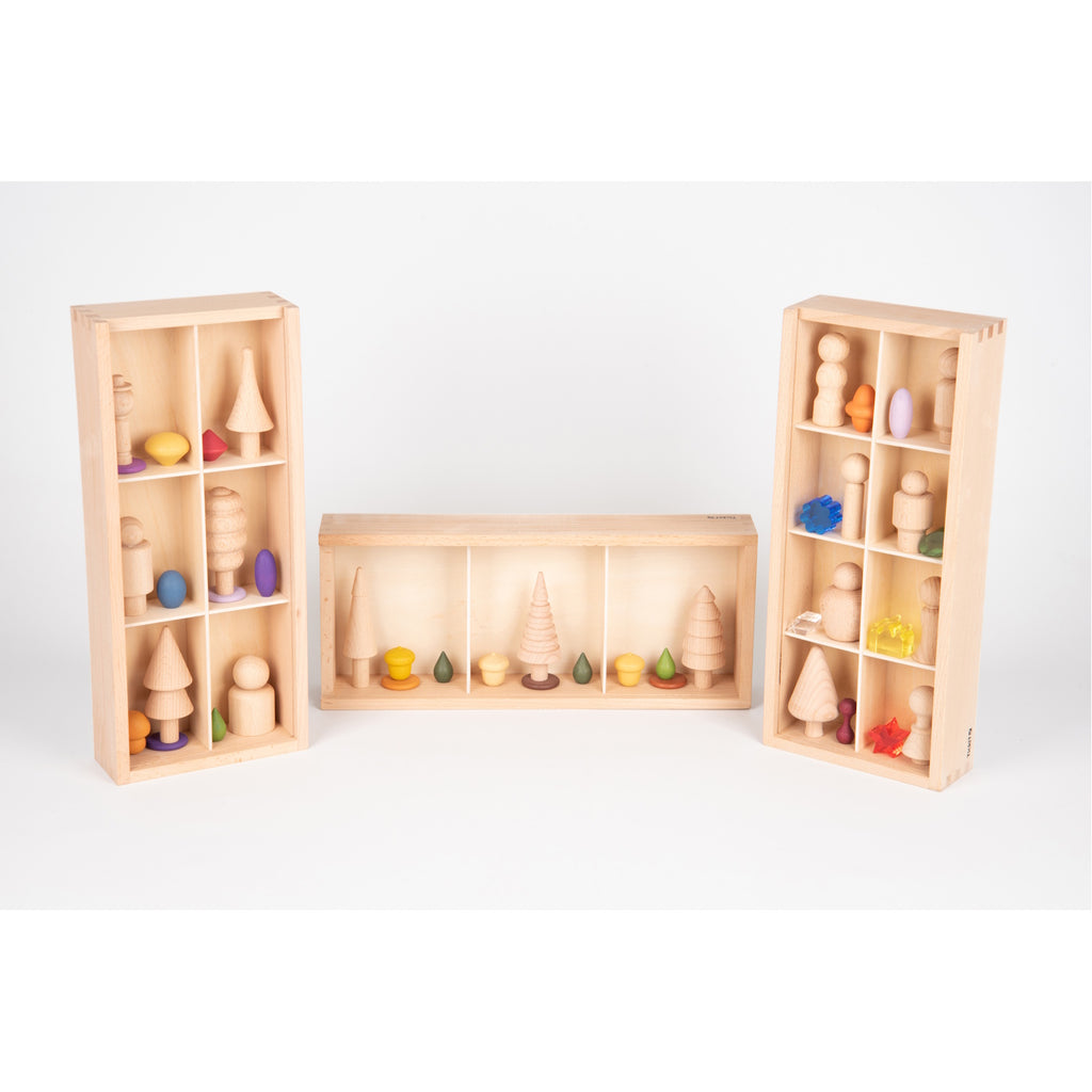 A set of natural wooden boxes with various openings and textures, designed to encourage sensory exploration and fine motor development in young children.