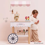 Child playing with a Le Toy Van wooden ice cream cart, with accessories sold separately.
