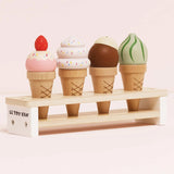 Four wooden toy ice cream cones in different flavors on a display stand.