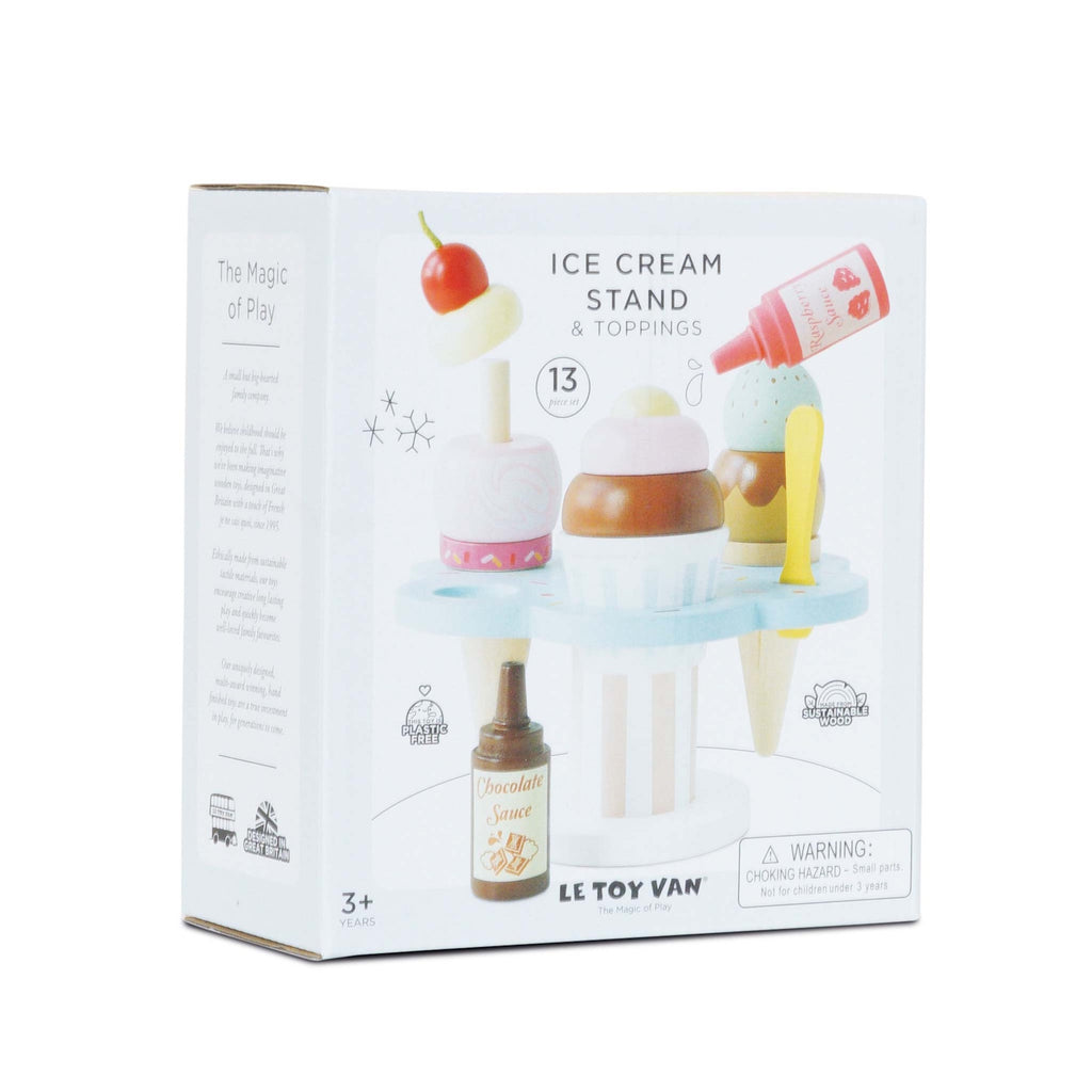 Toy ice cream stand box with colorful wooden ice cream and toppings. Features cones, a scoop, sauce, and cherry. Suitable for ages 3 and up.