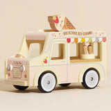 A pastel yellow and pink wooden toy ice cream van with a large ice cream cone on the roof.